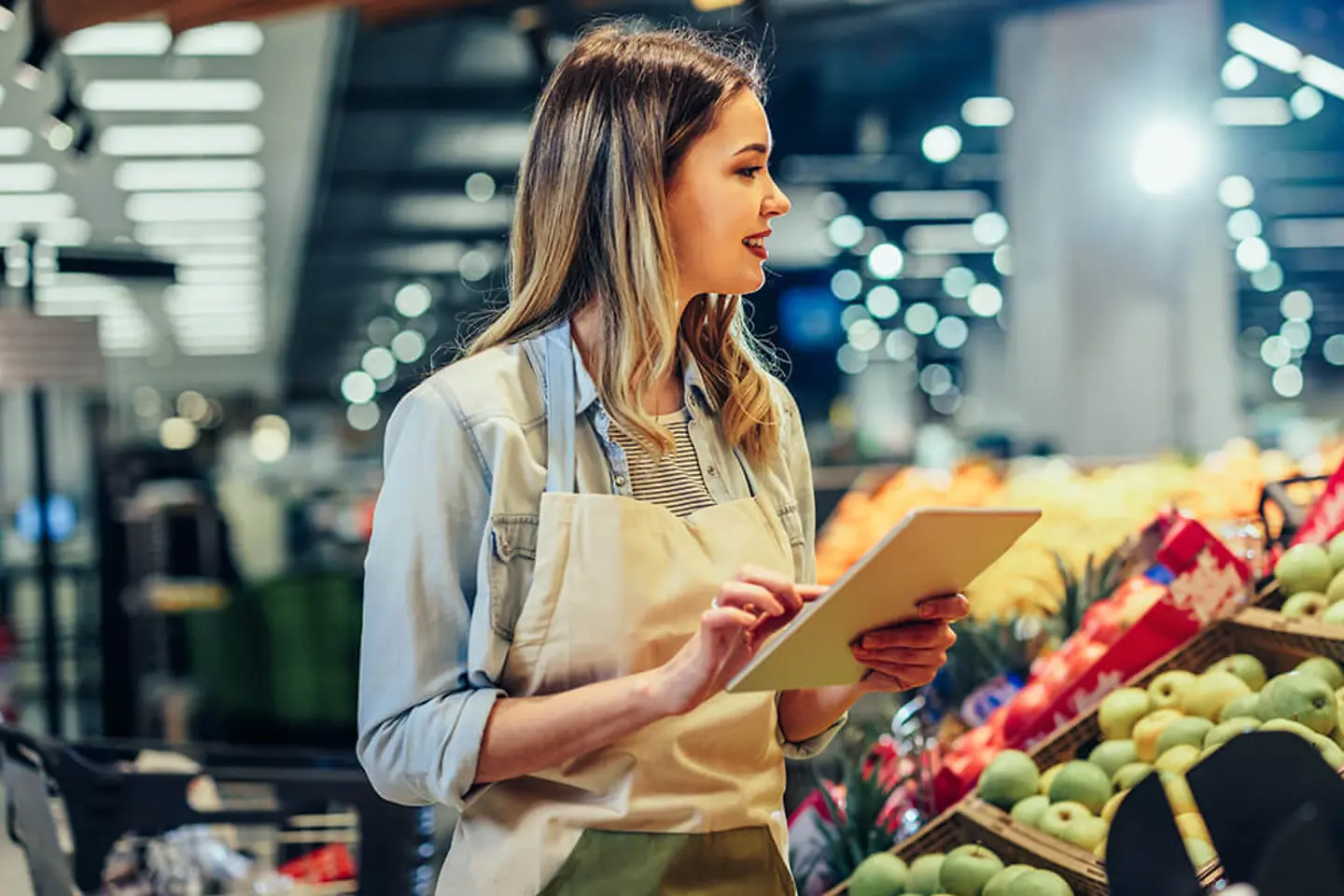 Woman working at a grocery store.