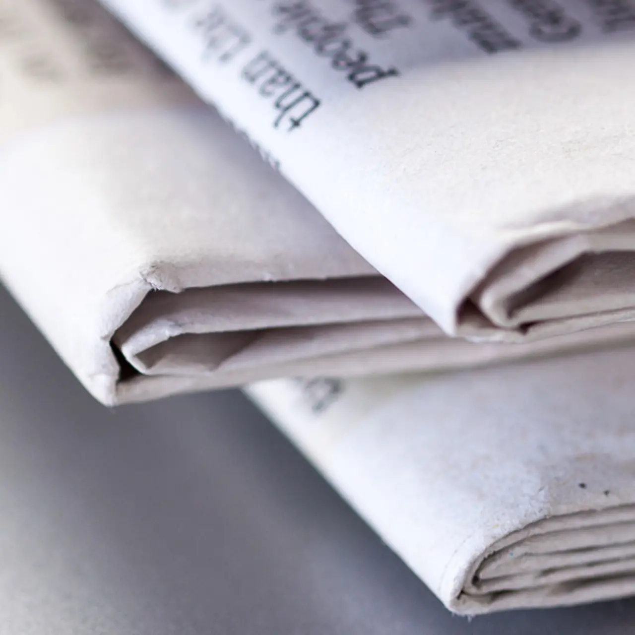 Close-up of the fold of a stack of newspapers