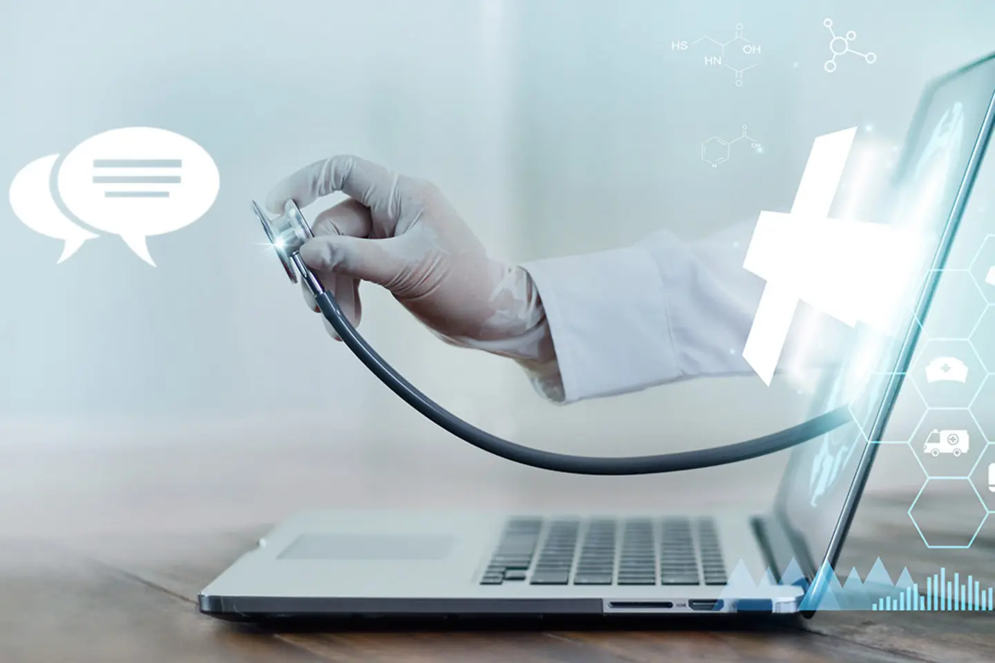 Doctor's hand with stethoscope protrudes from laptop screen